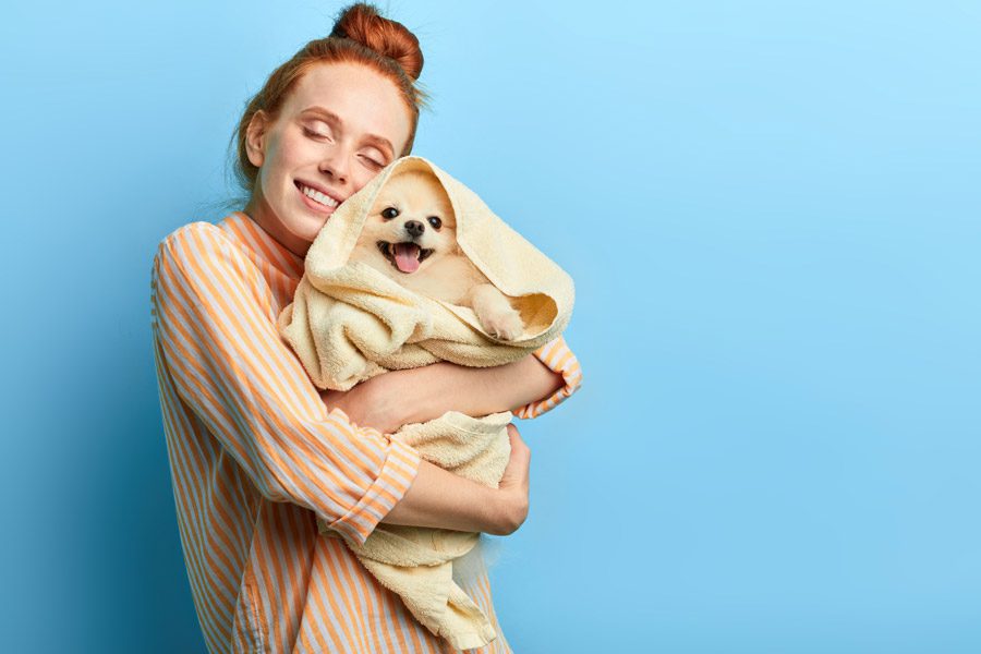 Palmetto Pups Groom & Play | Rock Hill, SC | redheaded woman hugging clean puppy